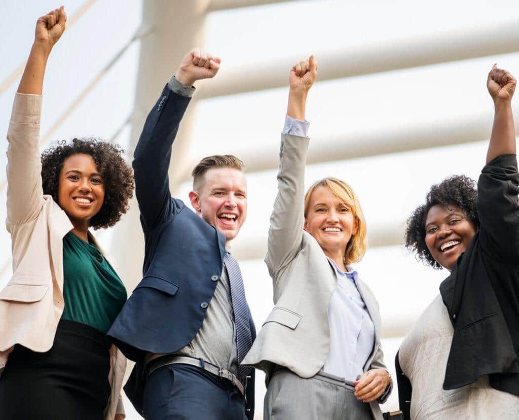 business casual people posing with fists in aie
