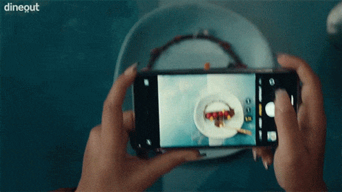 gif of someone taking an instagram pic because their vision was improved with Lasik