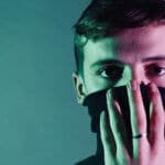 Man holding mask up to face