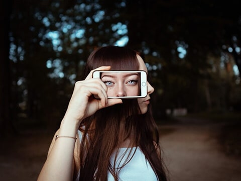 Woman's profile with camera showing eyes