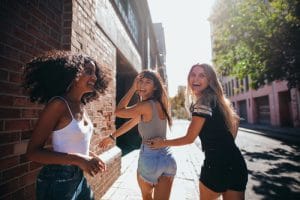 young girls walking on street