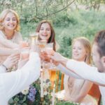 group of friends toasting at picnic