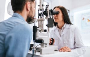 eye doctor performing eye exam on patient 