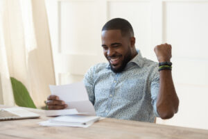 man smiling while sitting at table