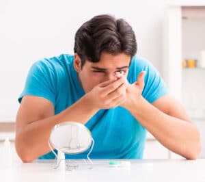 man putting contact lenses in