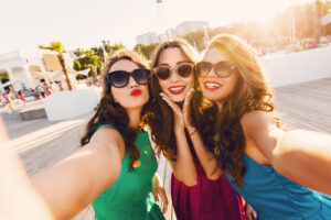 Three women happy about EVO ICL cost.