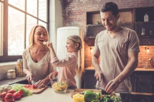 family cutting up produce