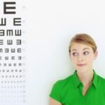 woman standing next to eye chart